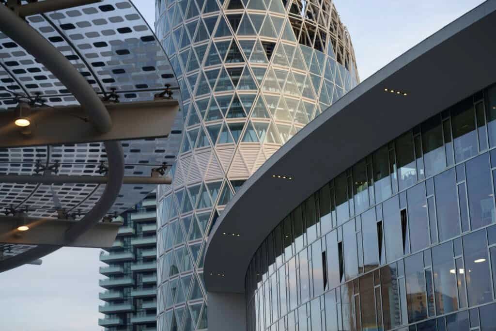 Modern architectural office building with glass and steel facade in the heart of a vibrant city.