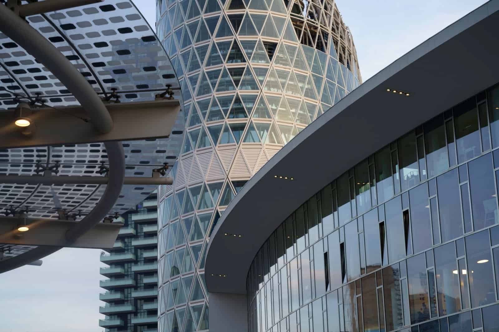 Modern architectural office building with glass and steel facade in the heart of a vibrant city.