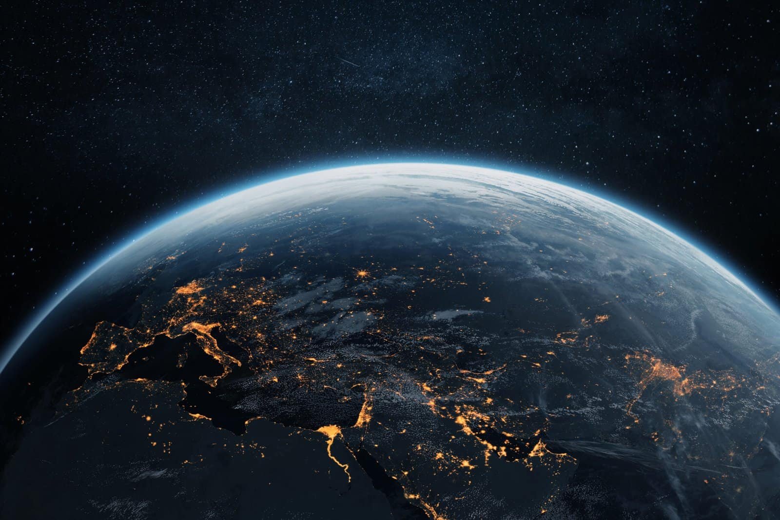 Bright view of Earth from space showcasing continents and illuminated cities at night, highlighting global connectivity and the importance of international cooperation in peace and sustainability.